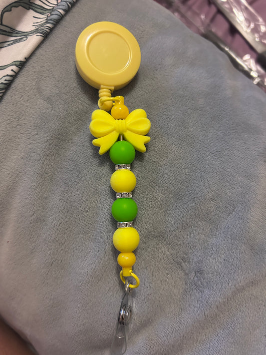 Yellow bow - badge reel